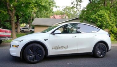 Tesla Robotaxi vehicle parked on a residential street ahead of the company's autonomous ride-hailing service expansion.
