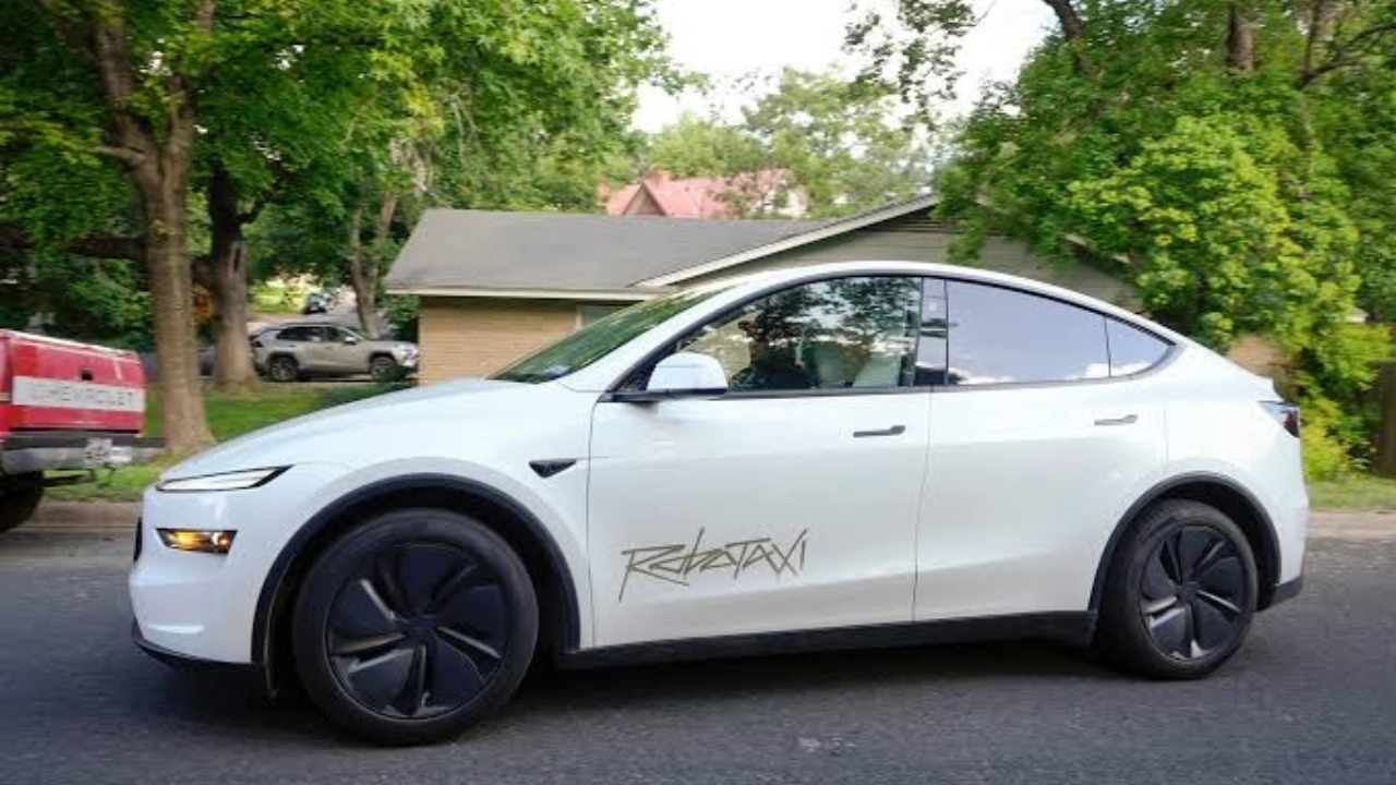 Tesla Robotaxi vehicle parked on a residential street ahead of the company's autonomous ride-hailing service expansion.