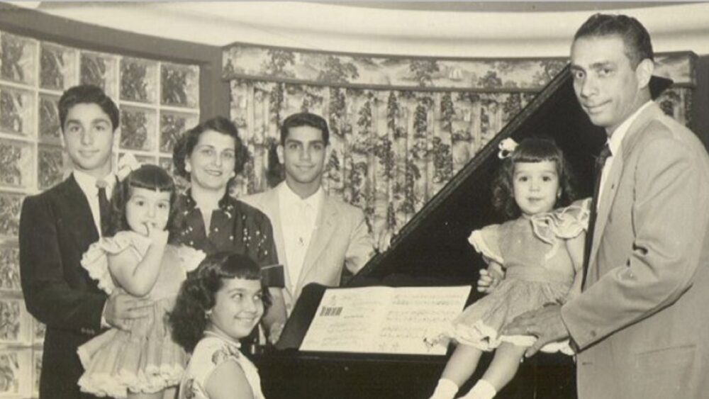 George Guida Sr. and his family gathered around a piano inside the historic Guida House in West Tampa.