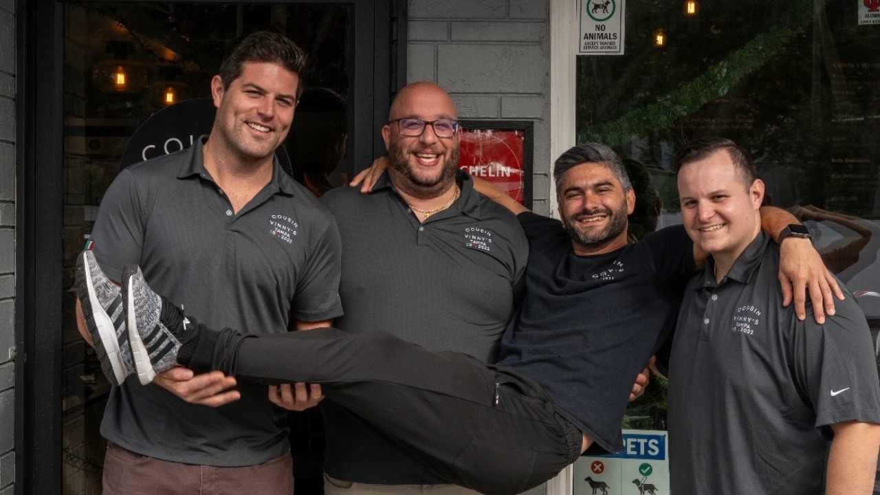 Four Cousin Vinny’s partners pose outside the Tampa restaurant. Title: Cousin Vinny’s partners
