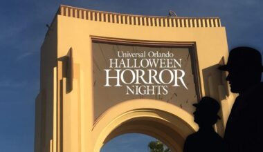 Universal Orlando’s iconic archway decked out for Halloween Horror Nights, with two mysterious hats in silhouette. Halloween Horror Nights haunted house.