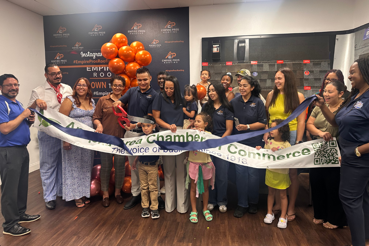 Empire Pros Roofing founder and CEO Ricardo Lopez Sandoval cuts the ribbon during the company’s renovation celebration Friday, July 17, at its Apopka office, surrounded by employees, family members and Apopka Area Chamber of Commerce representatives.