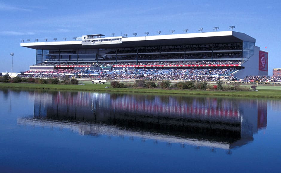 Photograph of the Woodbine Grandstand, reflected against the pond that resides in the racetrack’s infield. (Photo: ©Michael Burns)