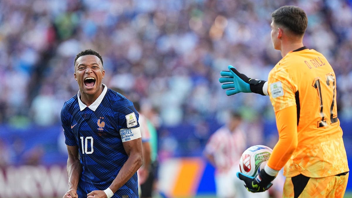 France's Kylian Mbappé (10) celebrates after France's victory over Paraguay in the World Cup round of 16.