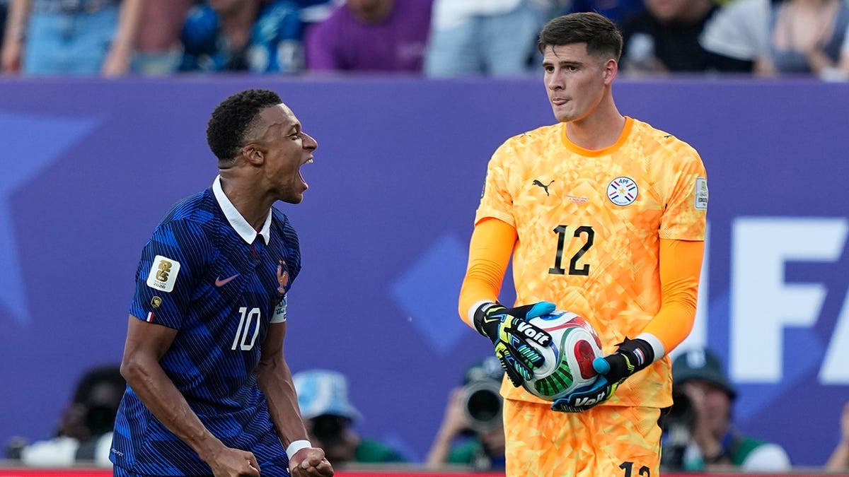 Kylian Mbappe celebrates as Paraguay goalkeeper Orlando Gill holds the ball after France's World Cup win.