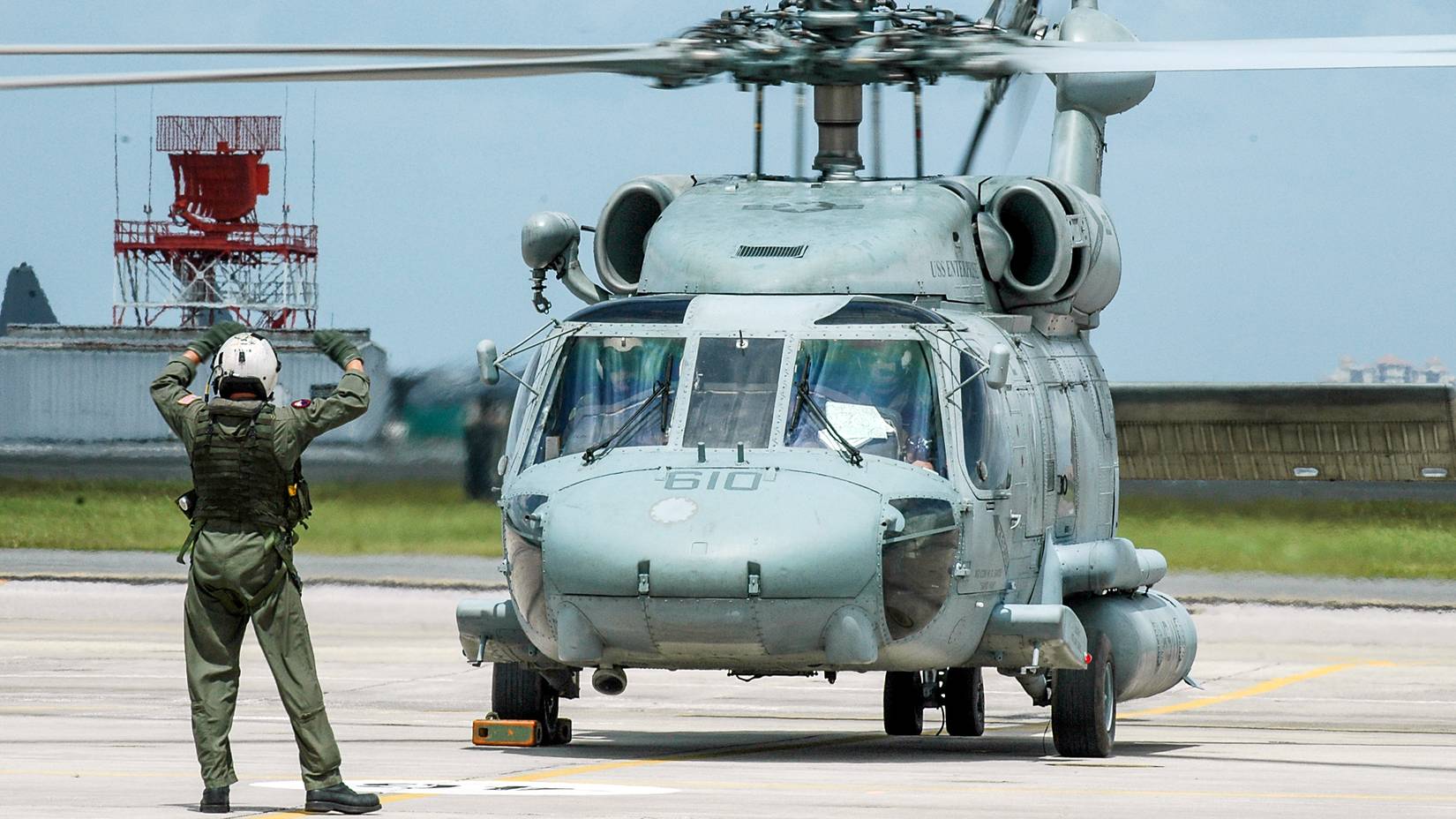 A helicopter crew prepare to depart Naval Air Station Jacksonville, Florida
