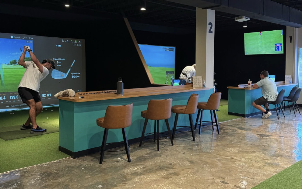 People inside a golf simulator
