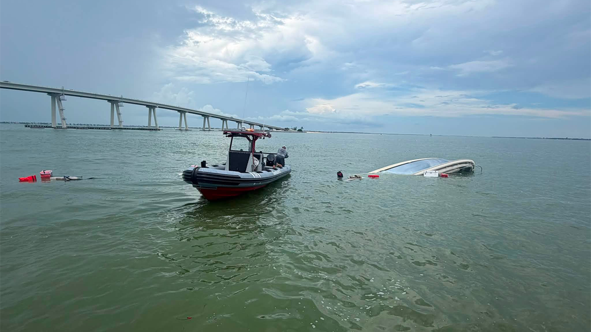 The U.S. Coast Guard shared photos of the boat nearly completely under water following the swift rescue.
