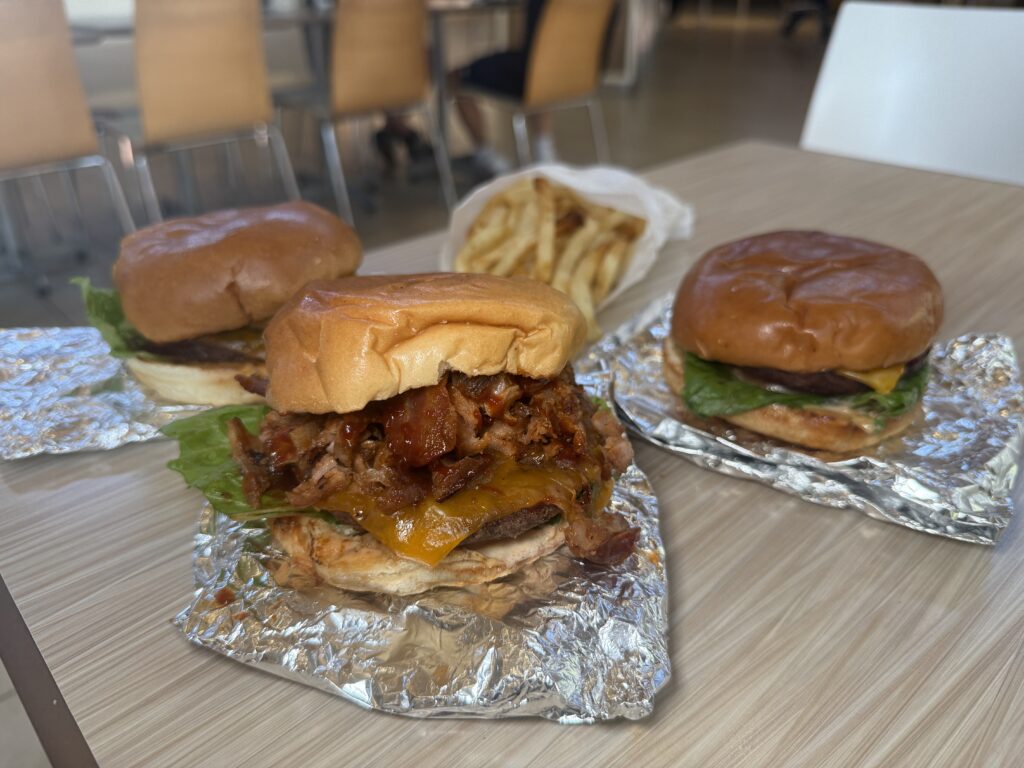 Three burgers on a table