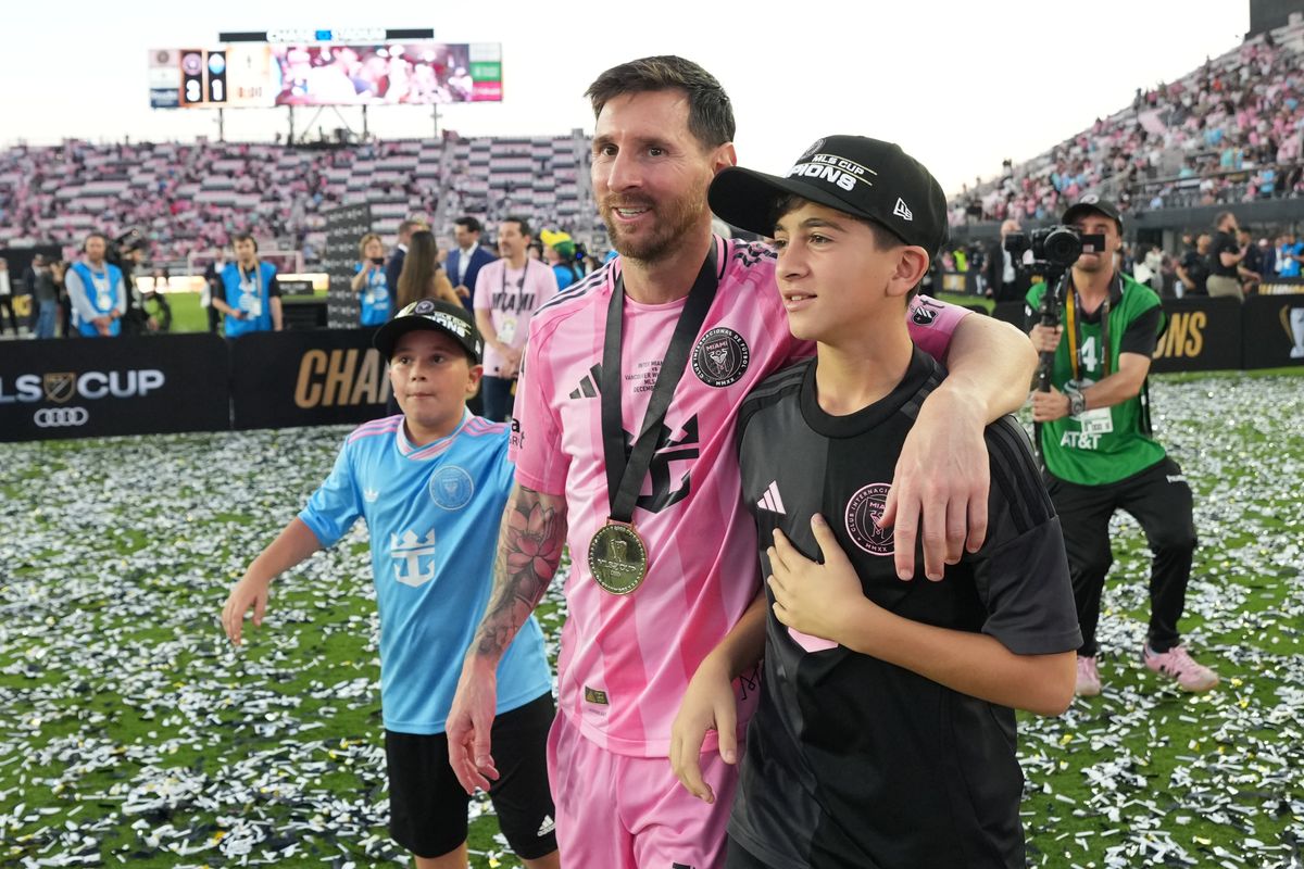 Lionel Messi #10 of Inter Miami CF celebrates with his sons Thiago Messi and Mateo Messi after winning the Championship