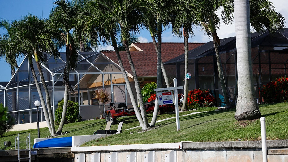 Cape Coral home backyards with for sale sign