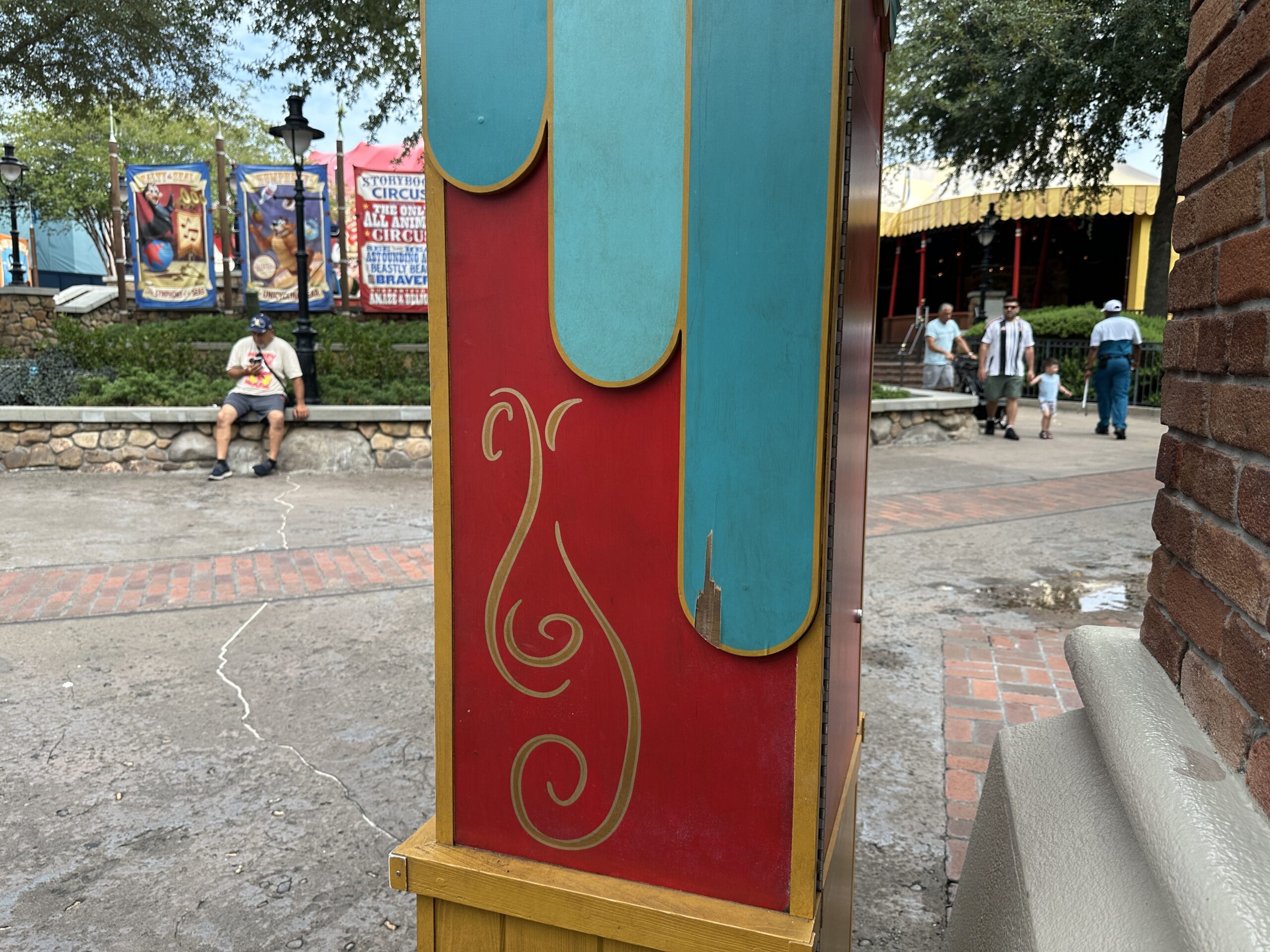 Pieces of the wood covering are splintering off around the machine, including near the bottom within reach of young guests.