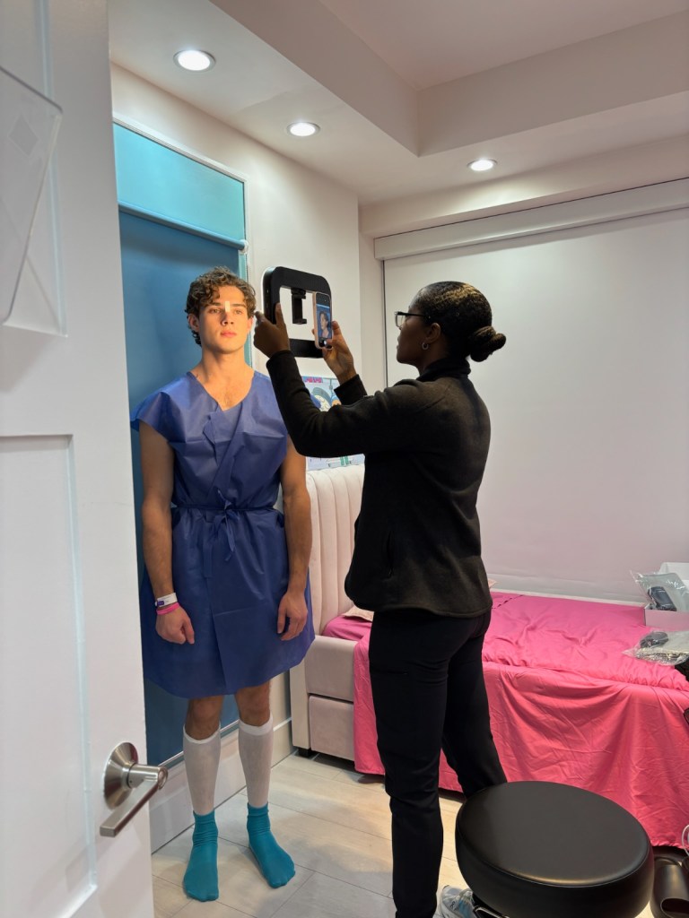 A photo of a man getting his photo taken by a nurse pre-surgery