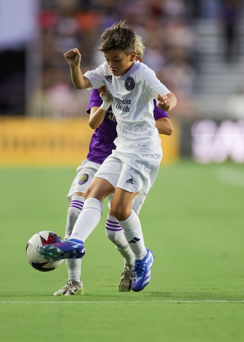 Thiago Messi #10 of IMCF U12 controls the ball against Nash Norris #80 of Orlando U12 during the Youth International Cup Opening Ceremony match