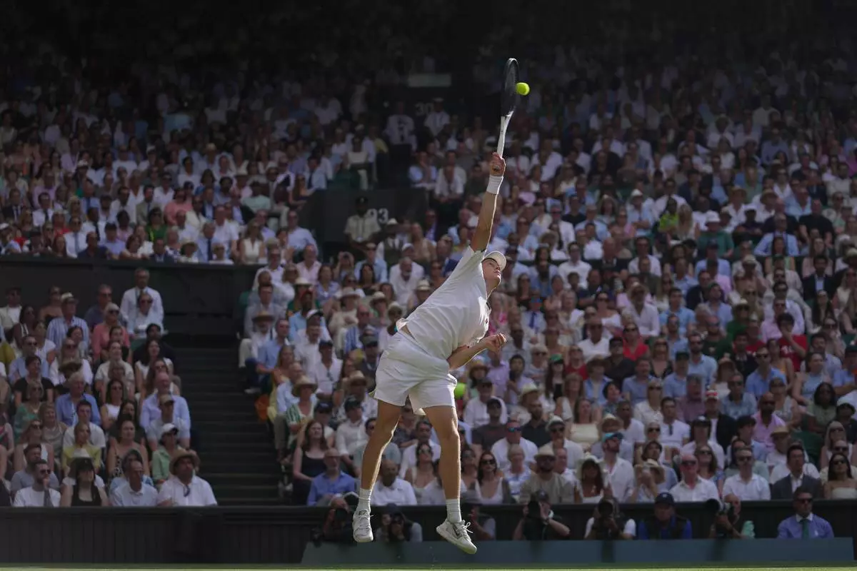 Jannik Sinner of Italy serves to Novak Djokovic of Serbia in their men's singles semifinal match at the Wimbledon Tennis Championships in London, Friday, July 10, 2026. (AP Photo/Brian Inganga)