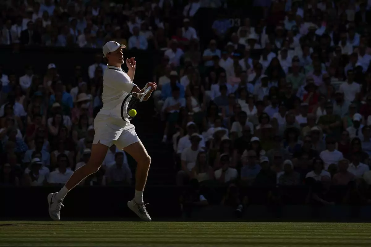 Jannik Sinner of Italy plays a return to Alexander Zverev of Germany men's singles final at Wimbledon Tennis Championships in London, Sunday, July 12, 2026. (AP Photo/Kin Cheung)