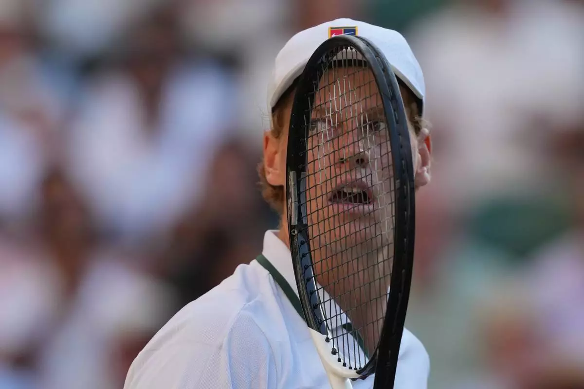 Jannik Sinner of Italy looks backwards his coaches during the as he plays against Alexander Zverev of Germany men's singles final at Wimbledon Tennis Championships in London, Sunday, July 12, 2026. (AP Photo/Kin Cheung)