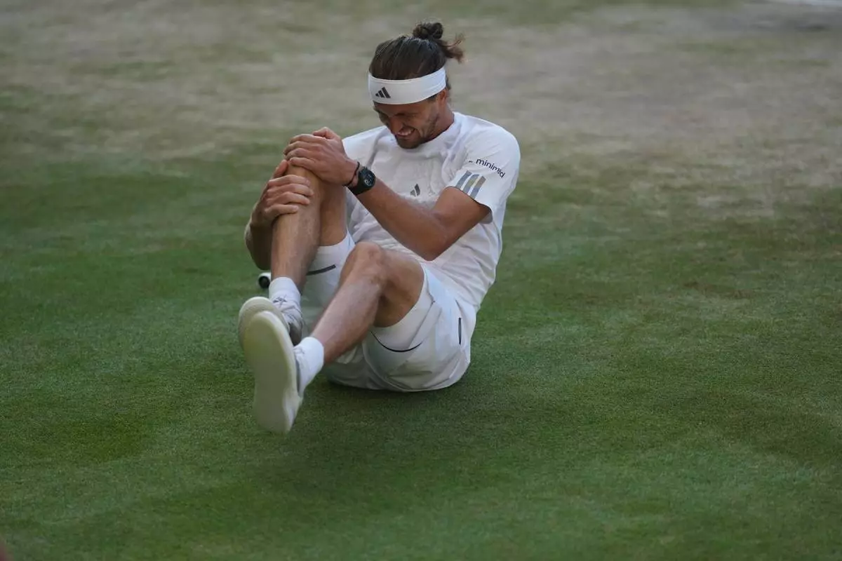 Alexander Zverev of Germany reacts after falling over during a point against Jannik Sinner of Italy in the men's singles final at Wimbledon Tennis Championships in London, Sunday, July 12, 2026. (AP Photo/Kirsty Wigglesworth)