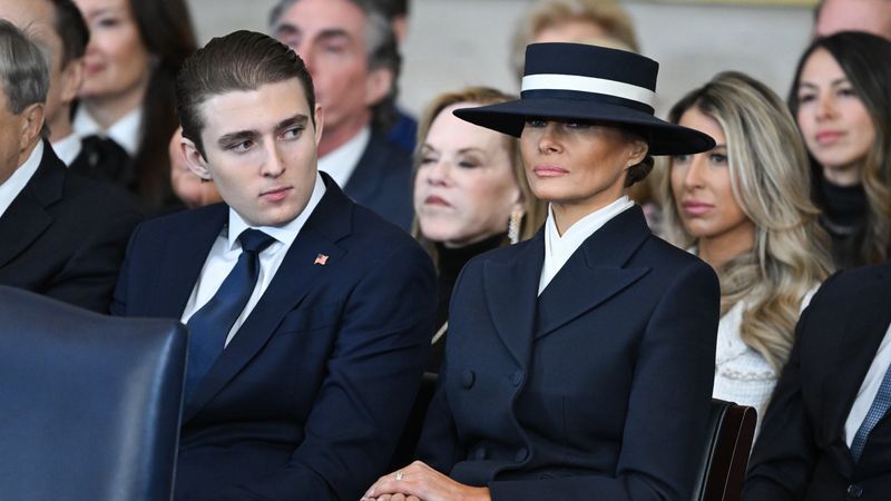 WASHINGTON, DC - JANUARY 20: Barron Trump and first lady Melania Trump listen as President Donald Trump gives his inaugural address in the U.S. Capitol Rotunda on January 20, 2025 in Washington, DC. Donald Trump takes office for his second term as the 47th president of the United States. (Photo by Saul Loeb - Pool/Getty Images)