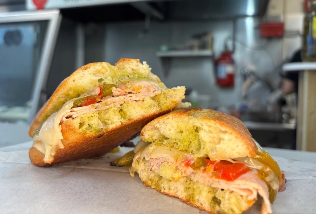 a turkey sandwich cut open with toppings