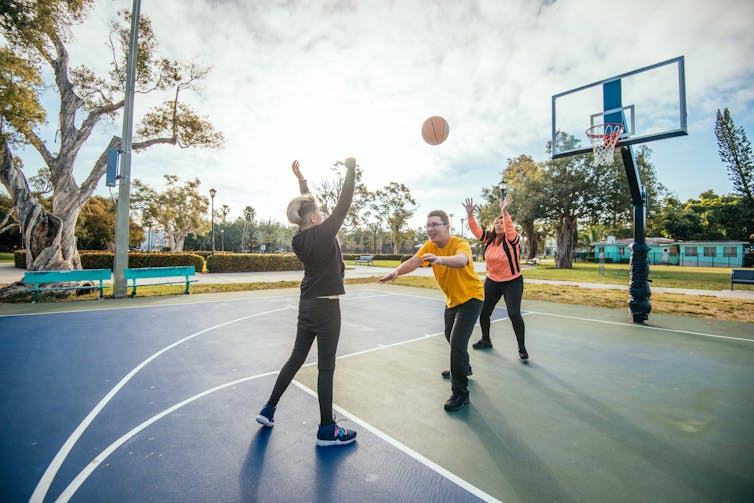 kids playing basketball at a park