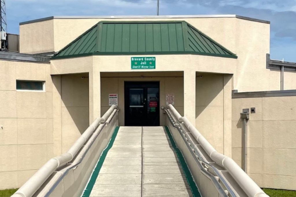 The entrance to the Brevard County Jail with a ramp leading to the double doors.