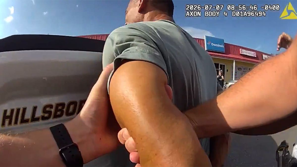 Rubiel Maceo Castillo being placed in handcuffs