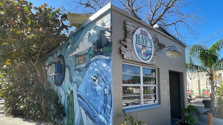 Exterior of Big Ray's Fish Camp in South Tampa, featuring a colorful fish mural on the building after the restaurant was named to Michelin's national seafood shack list.