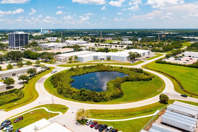 Aerial view of a three-building industrial portfolio in Tampa featuring warehouse buildings, parking areas and a stormwater pond.