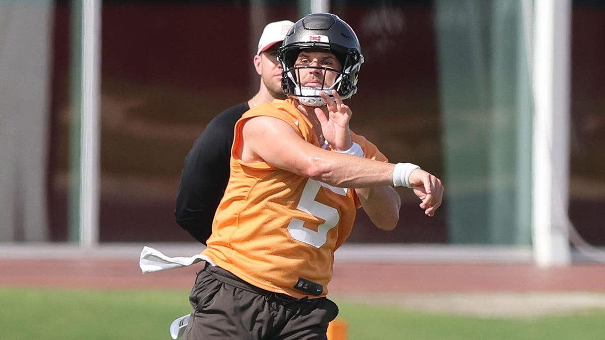 Jake Browning goes through drills during mini camp at the AdventHealth Training Center.