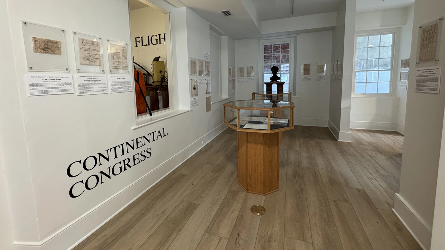 A hallway in the Karpeles Manuscript Museum with exhibits on the wall pertaining to the country's founding.
