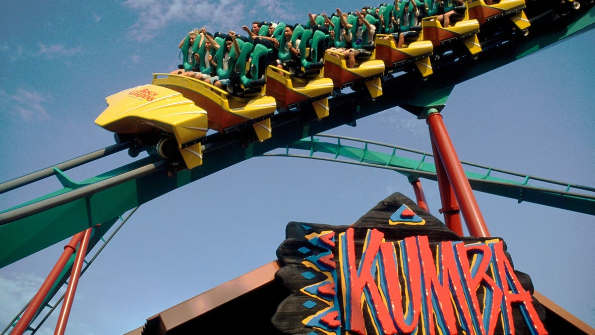 Kumba rollercoaster curves against a clear blue sky.