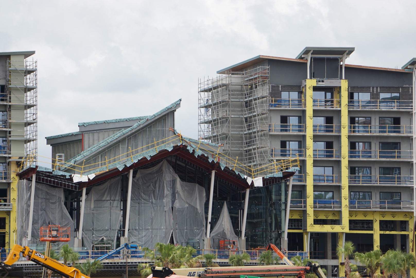 It appears that dark gray siding or paint is being added to the building section to the left of the porte-cochère.