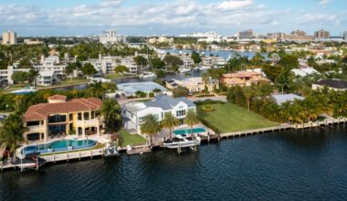 Aerial drone shot of sunrise key neighborhood in Fort Lauderdale, you can see the Rio Barcelona canal, modern and luxury houses, blue sky boats and tropical climate