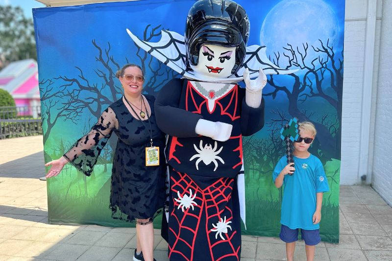 Legoland Florida Halloween character posing with mom and son