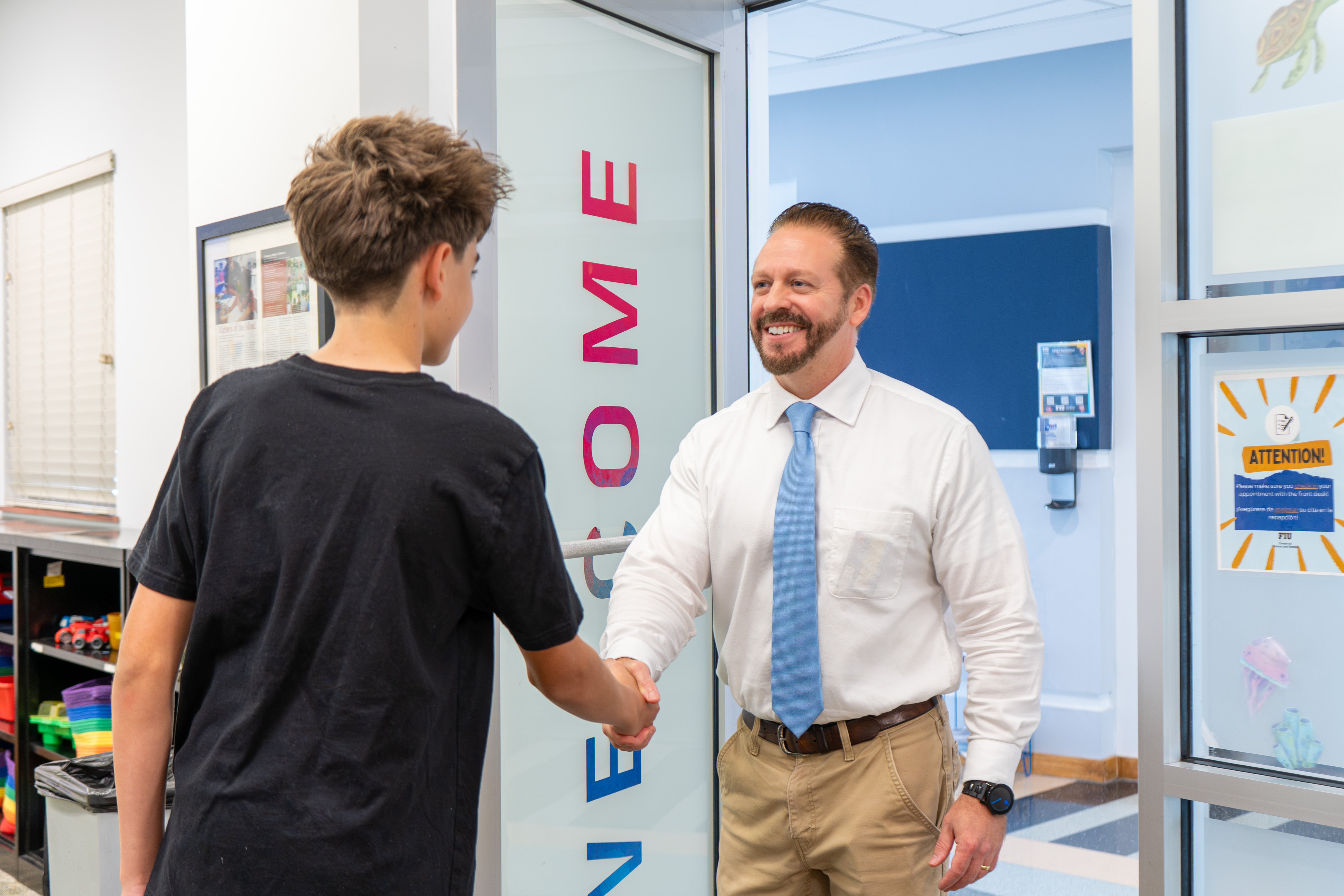 Dr. Jeremy Pettit greets Liam, who will test out the Eco-Rescue game