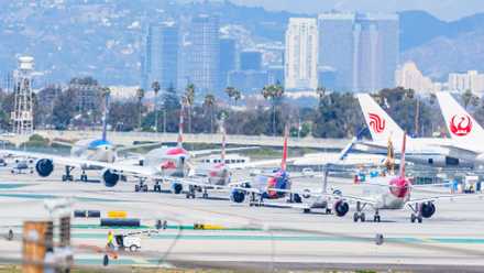 Many aircraft is lined up for departure at Los Angeles International Airport (LAX).