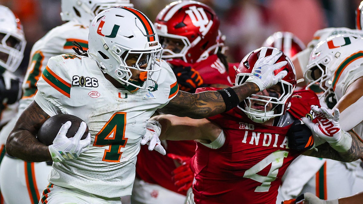 Mark Fletcher Jr stiff arms a defender