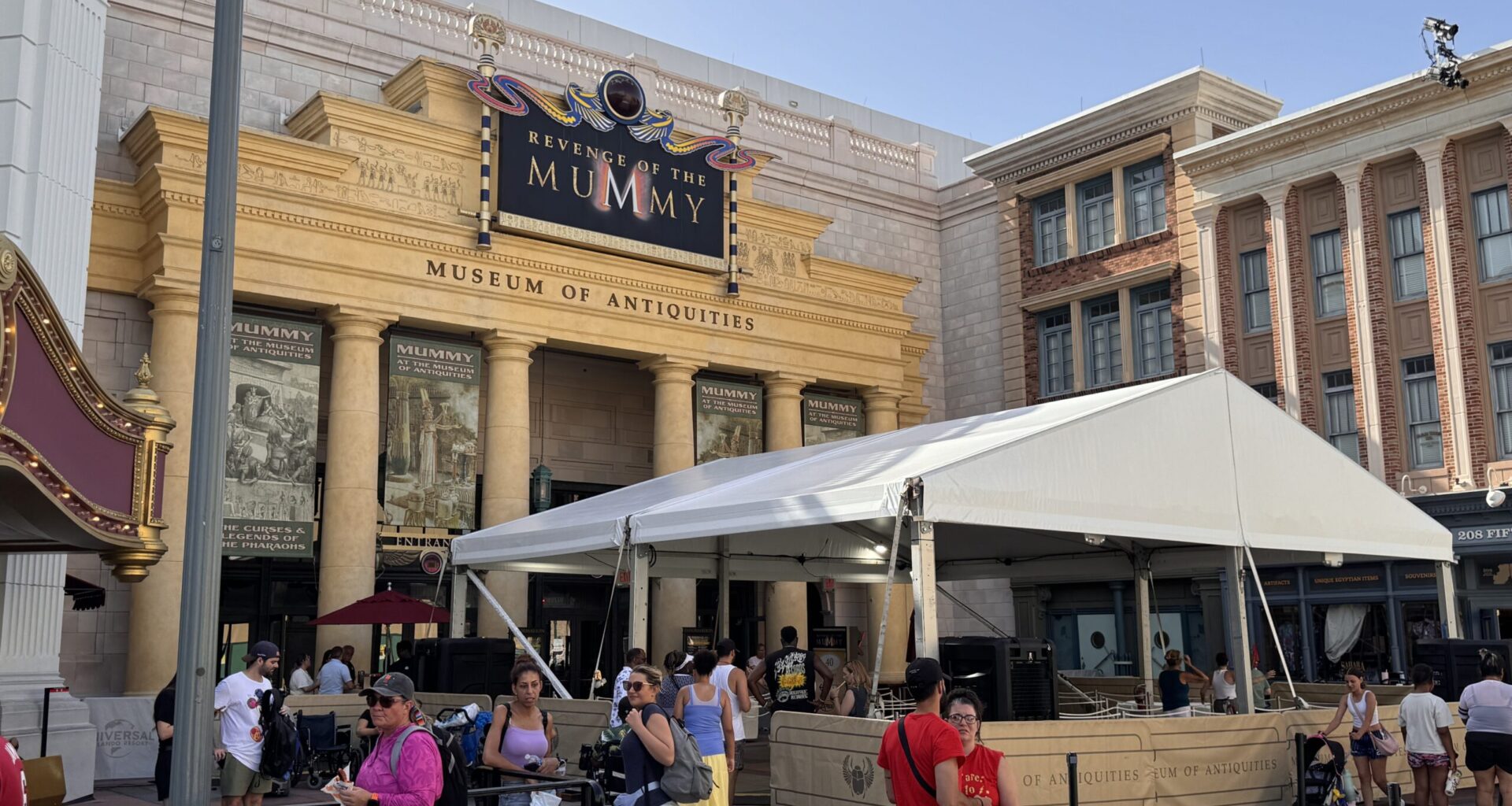 The covered queue is surrounded by barriers featuring