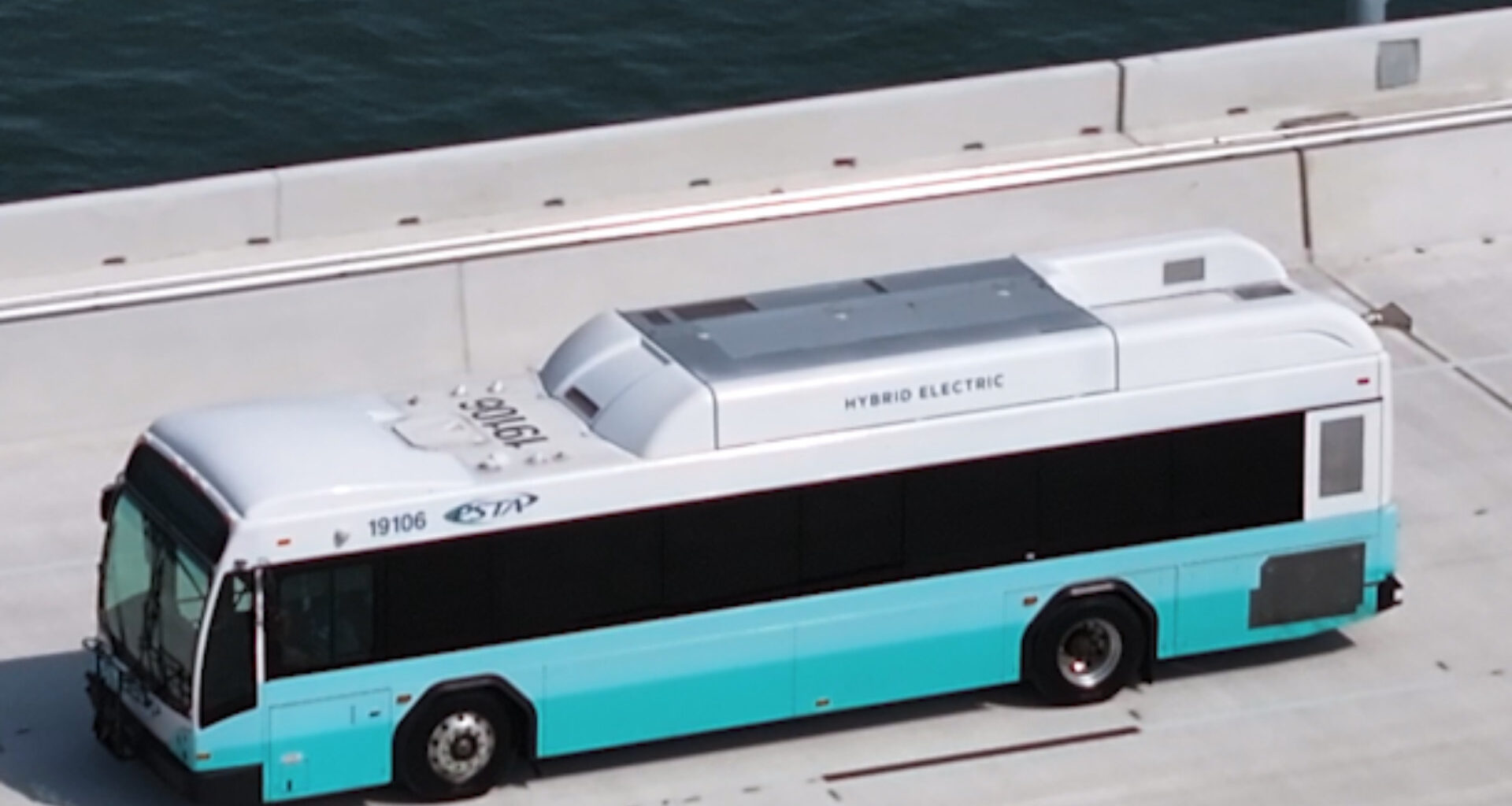 A bus riding by the water
