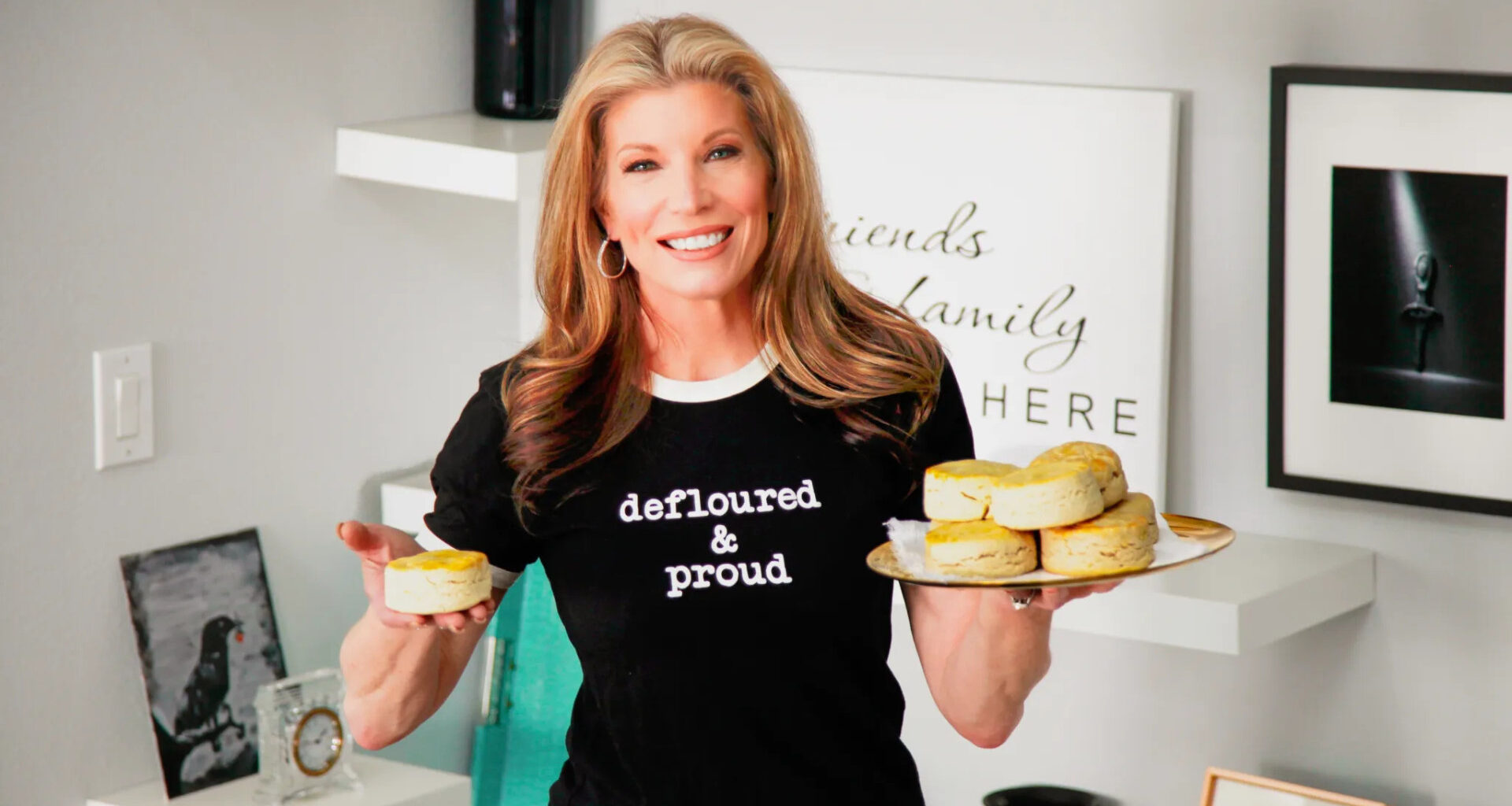 The Clever Deli owner holding up food