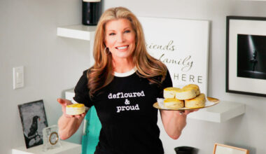 The Clever Deli owner holding up food