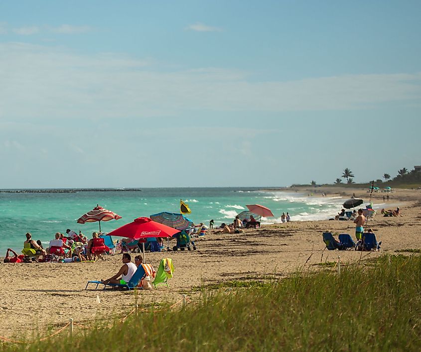 Tourists are enjoying at a beach in Stuart, Florida. Image credit: Klimamarina via Shutterstock.