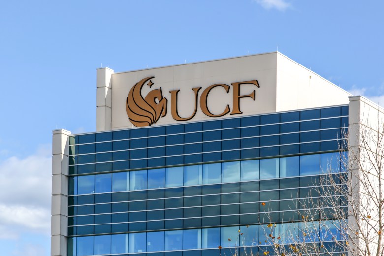 UCF College of Medicine building exterior at the Lake Nona Campus in Orlando Florida featuring the University of Central Florida sign and logo on a modern glass facade.