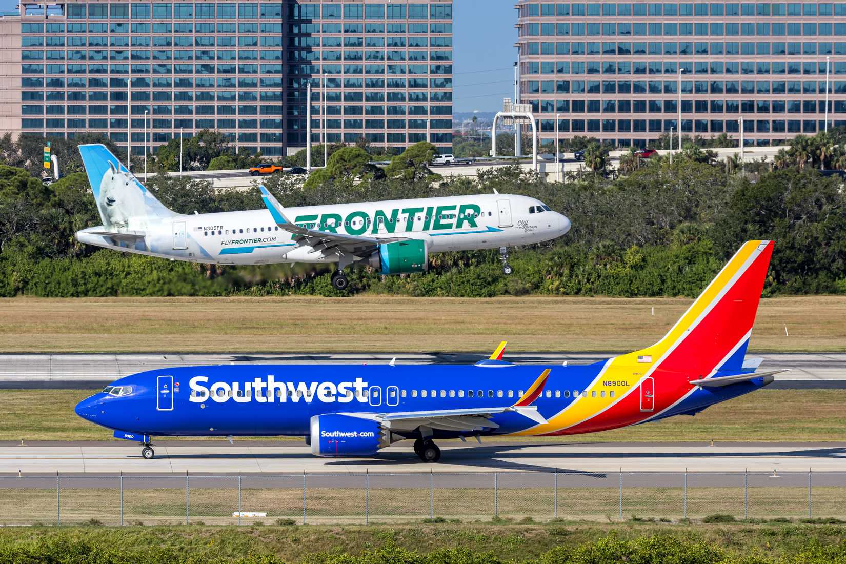 Tampa, United States - November 7, 2025: Southwest Airlines Boeing 737 MAX 8 and Frontier Airlines Airbus A320neo airplanes at Tampa airport in the United States.