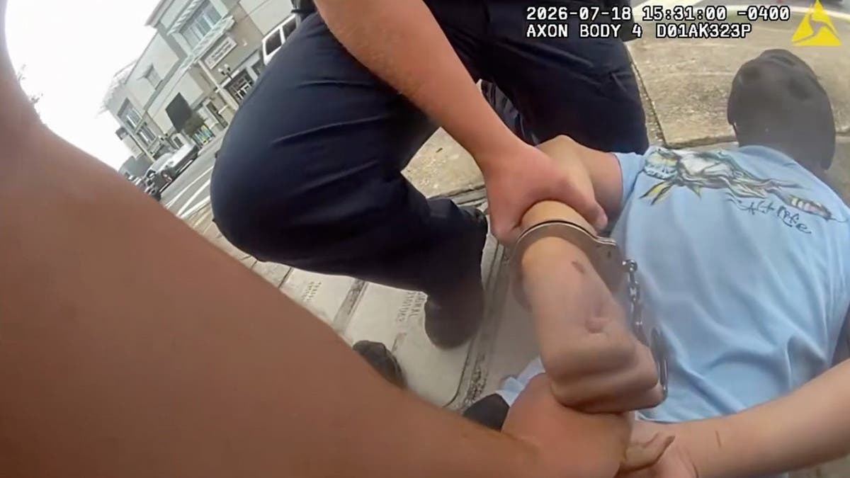 photo shows still shot from bodycam of teen in cuffs