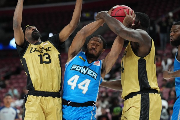 Dallas Power's Elijah Stewart (44) battles for a loose ball with Detroit Amps' Corey Brewer (13) and Darnell Jackson (4) during a BIG3 basketball game at Amerant Bank Arena on Sunday, July 5, 2026 (Jim Rassol/Contributor).
