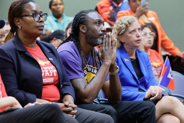 Harris Harrigan, center, and U.S. Rep. Debbie Wasserman Schultz, right, to protest the end of temporary protected status for Haitians on July 10, 2026. (Mike Stocker/South Florida Sun Sentinel)