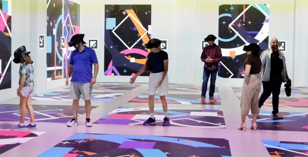 Visitors enjoy a virtual reality experience during the "Napoleon: The Immersive Saga" and "Colosseum: The Legendary Arena" exhibits at South Florida PBS in Boynton Beach on Tuesday, June 23, 2026. (Carline Jean/South Florida Sun Sentinel)