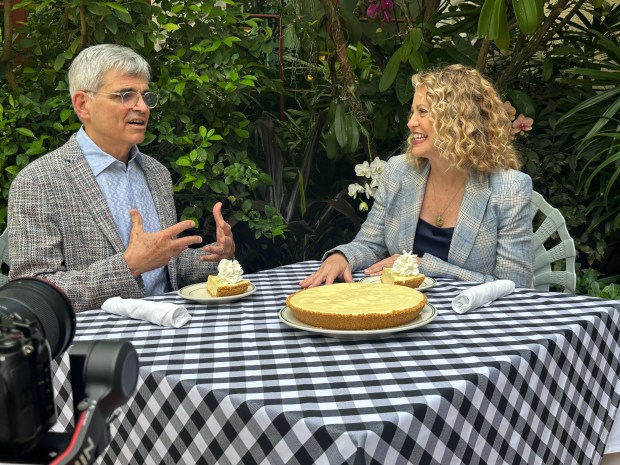 Stephen Sawitz, left, and chef-host Michelle Bernstein at the table at Joe's Stone Crab in Miami Beach, one of eight restaurants featured in the new PBS film "Legacy on a Plate: The Restaurants That Built South Florida." (PBS/Courtesy)